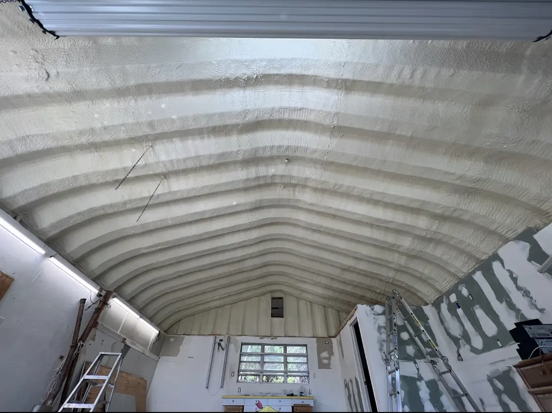 Spray polyurethane foam applied to the underside of a metal roof deck in Clayton